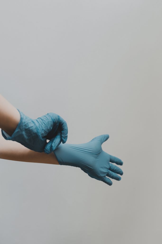 person putting on surgical gloves