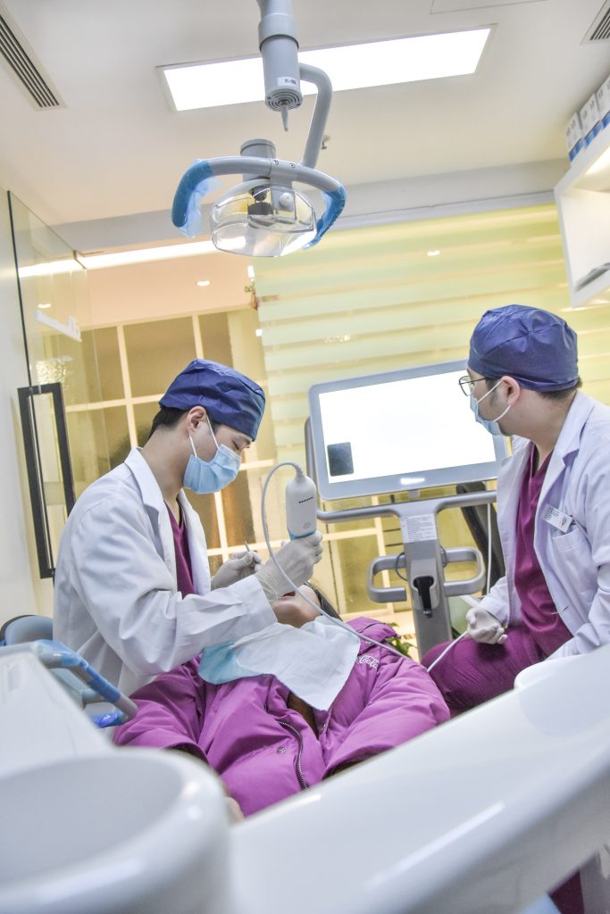 two dentists working on patient